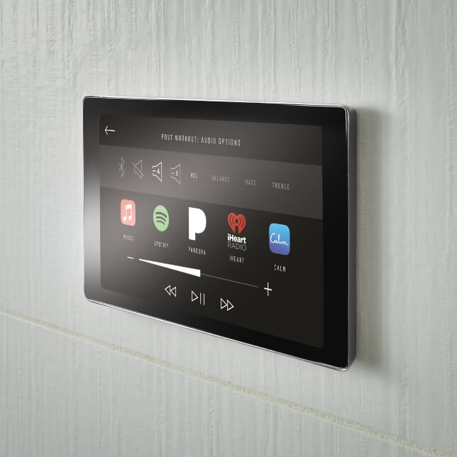 Mystix™ Audiotherapy controls depicted on the SensoriPlus™ Digital Interface, a rectangular touch-screen panel. The panel shows icons for Apple Music™, Spotify®, Pandora®, iHeartRadio® and Calm™.